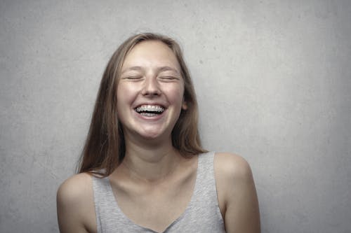 Free Woman in Gray Tank Top Laughing Stock Photo