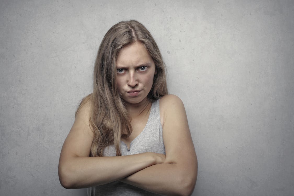 Woman in Gray Tank Top Looking Furious