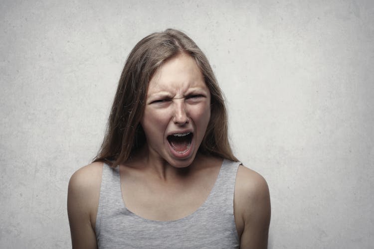 Woman In Gray Tank Top Shouting