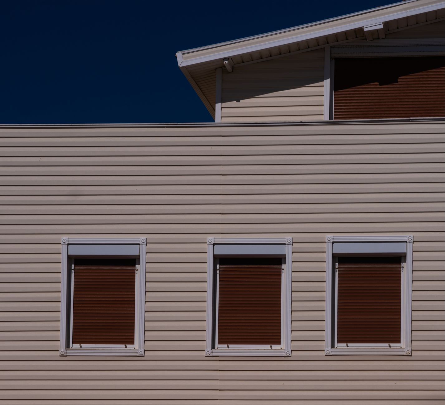 Minimalist view of a modern building facade with closed windows in Foça, Turkey.