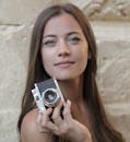 Woman Holding Silver and Black Camera