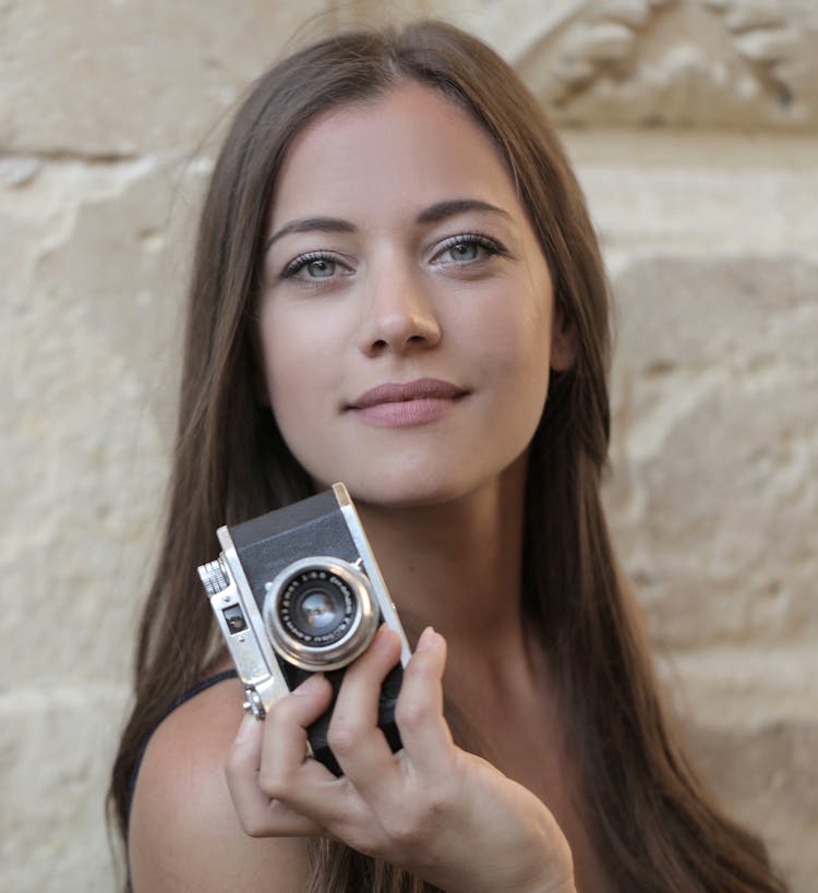 Woman Holding Silver And Black Camera