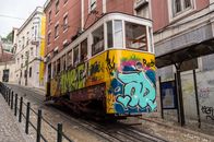 Yellow and Multicolored Cable Train Beside Brown and White Concrete Building