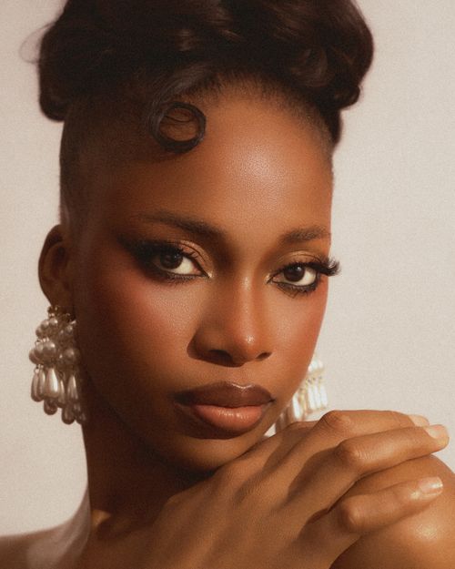 Free Stunning portrait of a Nigerian woman with elegant styling and pearl jewelry. Stock Photo