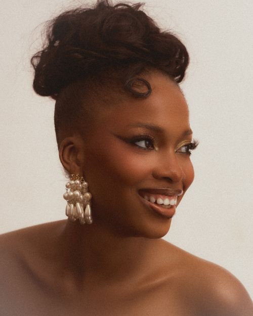 Free Beautiful African woman in Lagos with elegant hairstyle and makeup highlighting natural beauty. Stock Photo