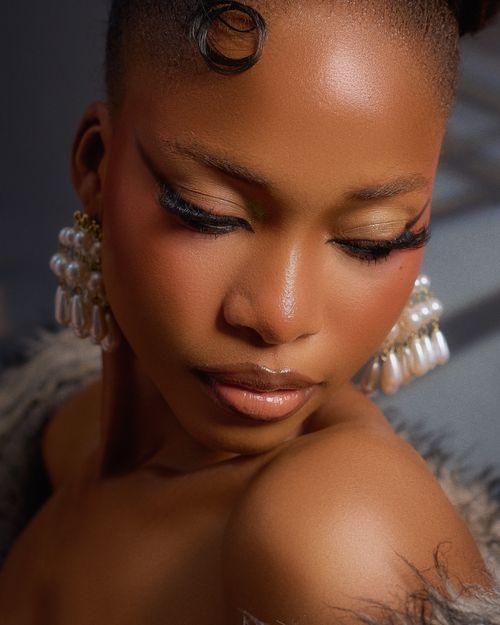 Free Close-up portrait of a young woman with elegant earrings, showcasing beauty and style. Stock Photo