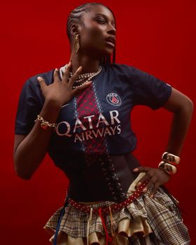 A striking fashion portrait featuring bold accessories and a red backdrop, highlighting contemporary style in Lagos.