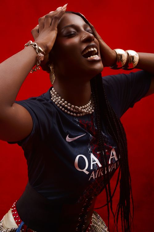 Free Dynamic image of a joyful woman expressing emotion against a vivid red background in Lagos, Nigeria. Stock Photo