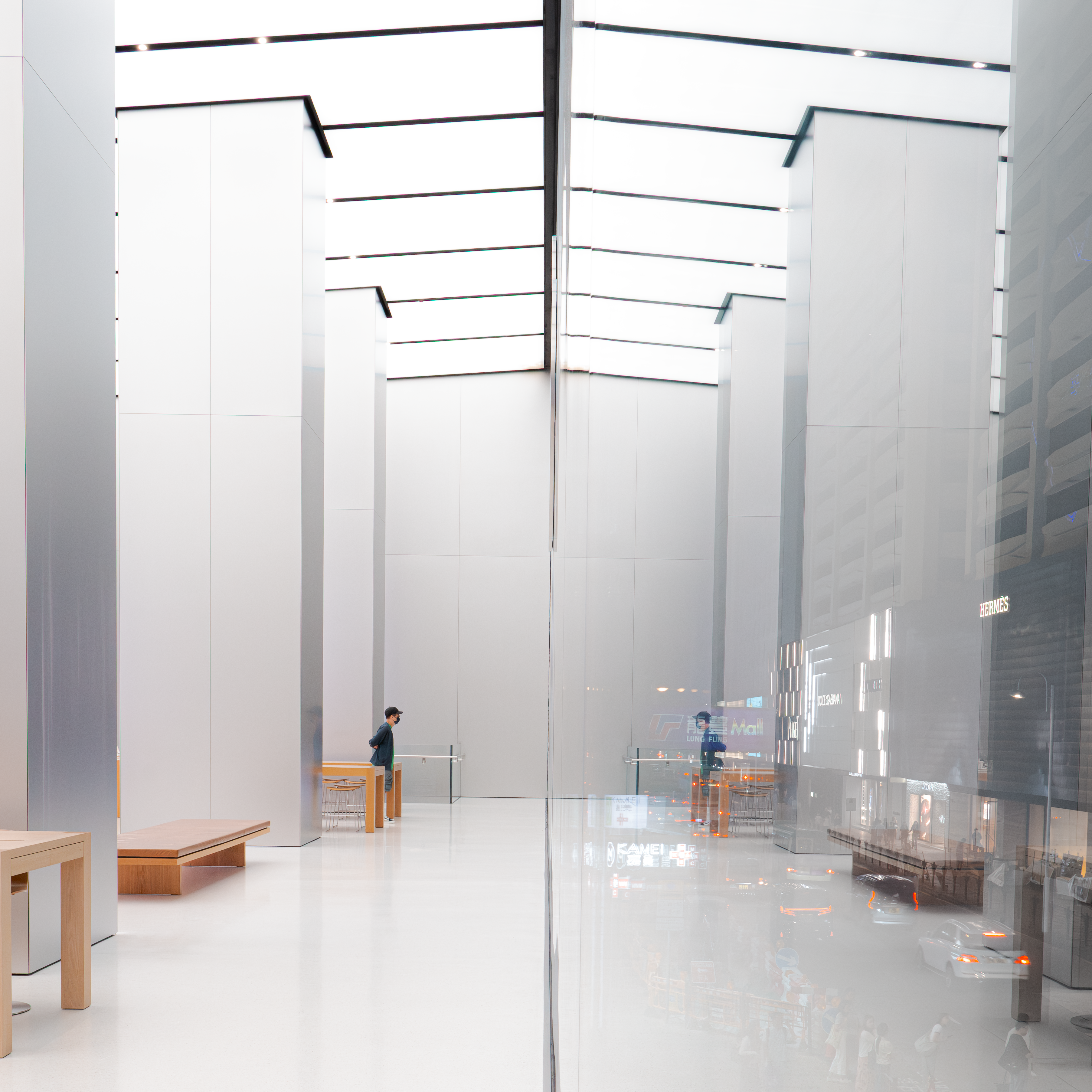 Minimalist interior design showcasing architectural style with glass reflections in Kowloon, Hong Kong.