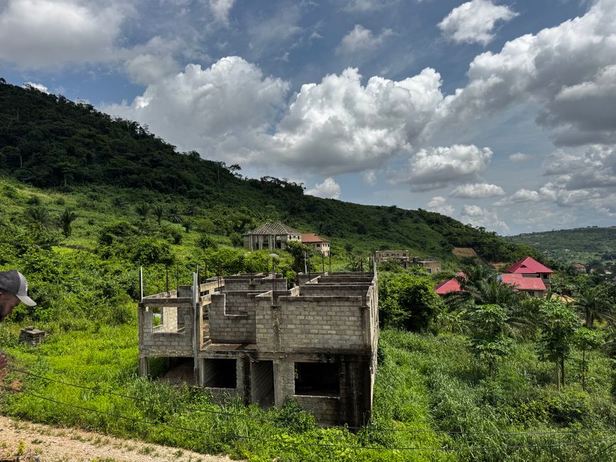 Partial construction with lush greenery in Greater Accra Region, Ghana.