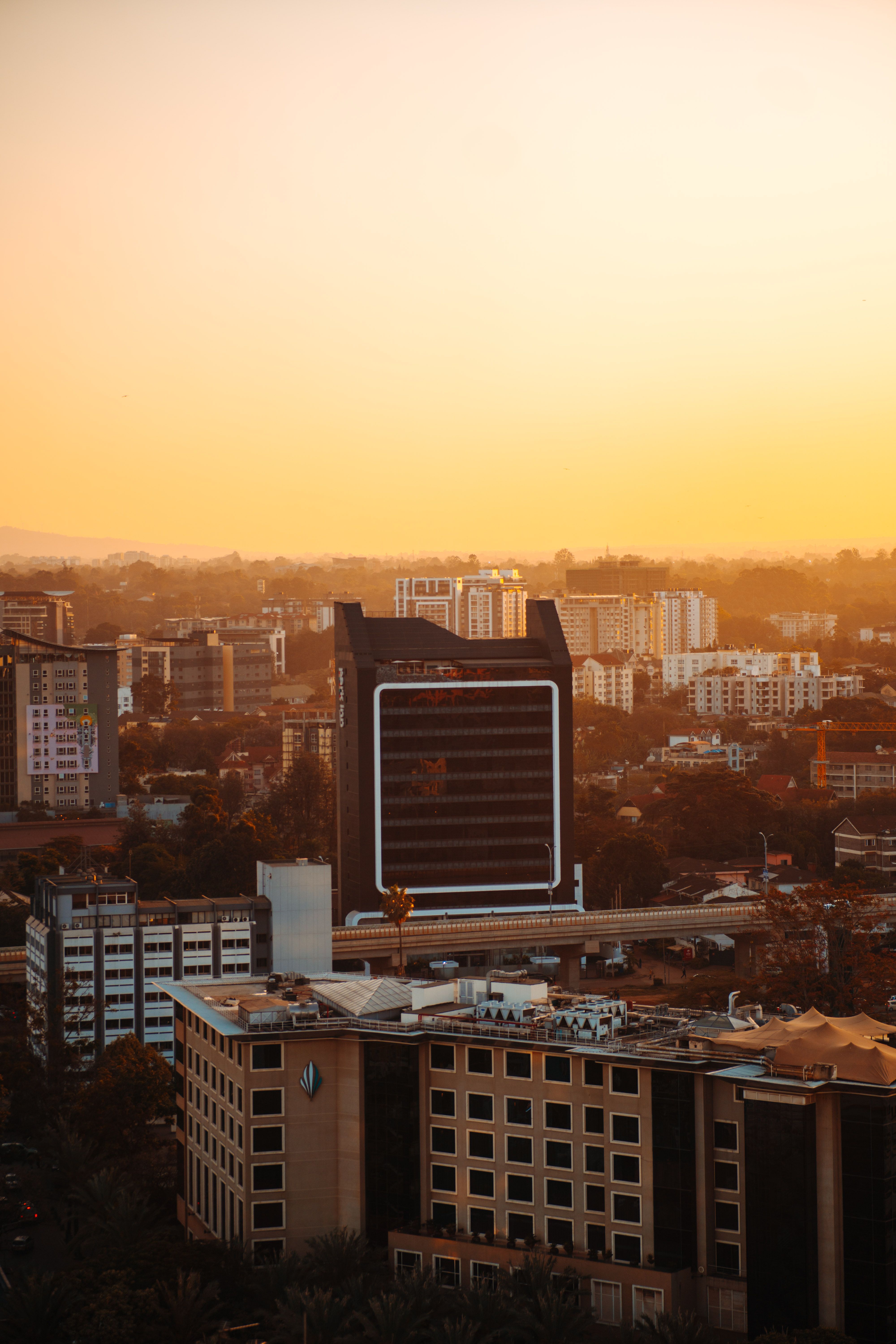 Aerial view of Nairobi's cityscape during a warm sunset, showcasing Kenyan architecture.
