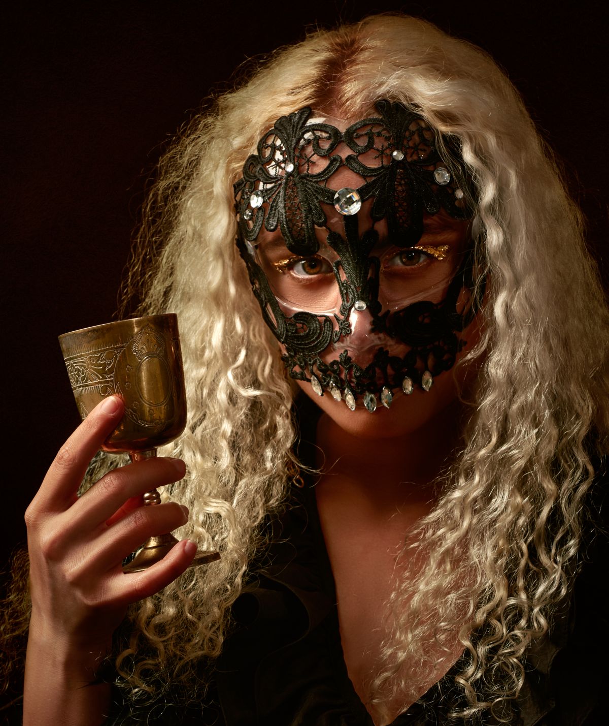 A woman wearing a mysterious black lace masquerade mask, party games for adults without alcohol