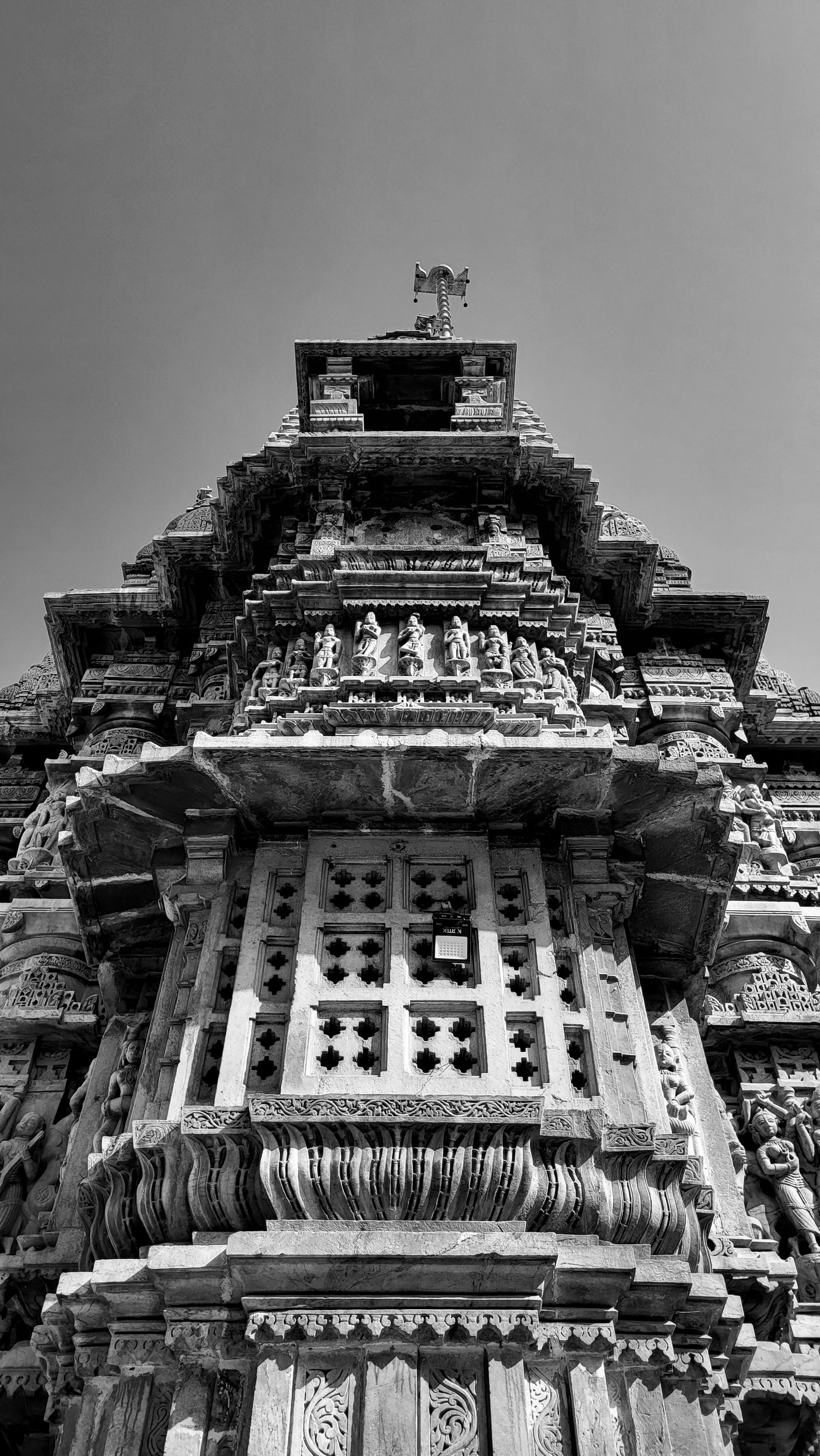 Intricate stone carvings on a historic temple in Udaipur, showcasing traditional Indian architecture.
