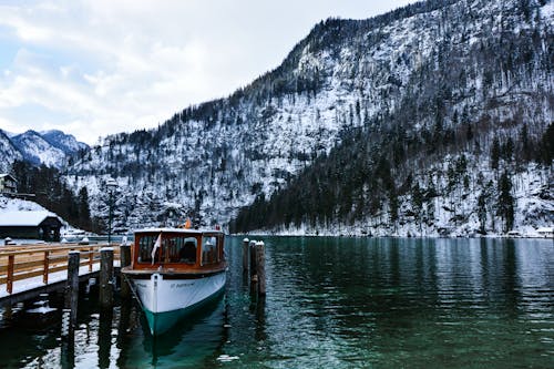 A Boat on Dock near a Snow-Covered Mountain