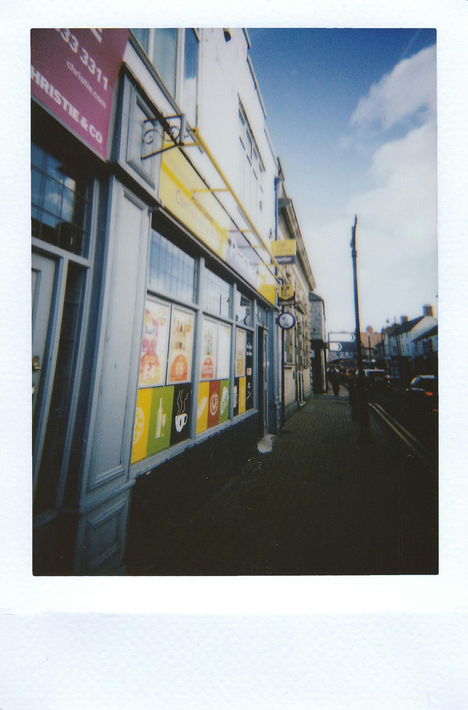 A colorful storefront in the vibrant streets of Abergele, Wales captured on an instant photo.