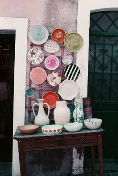 Vibrant ceramics artfully arranged in Lisbon, showcasing diverse patterns and colors.