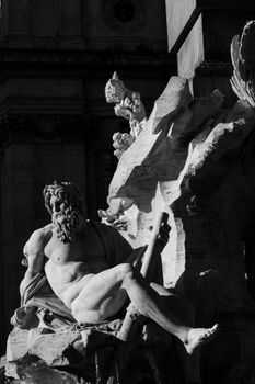 Black and white photo of a Rome fountain statue with dramatic lighting.