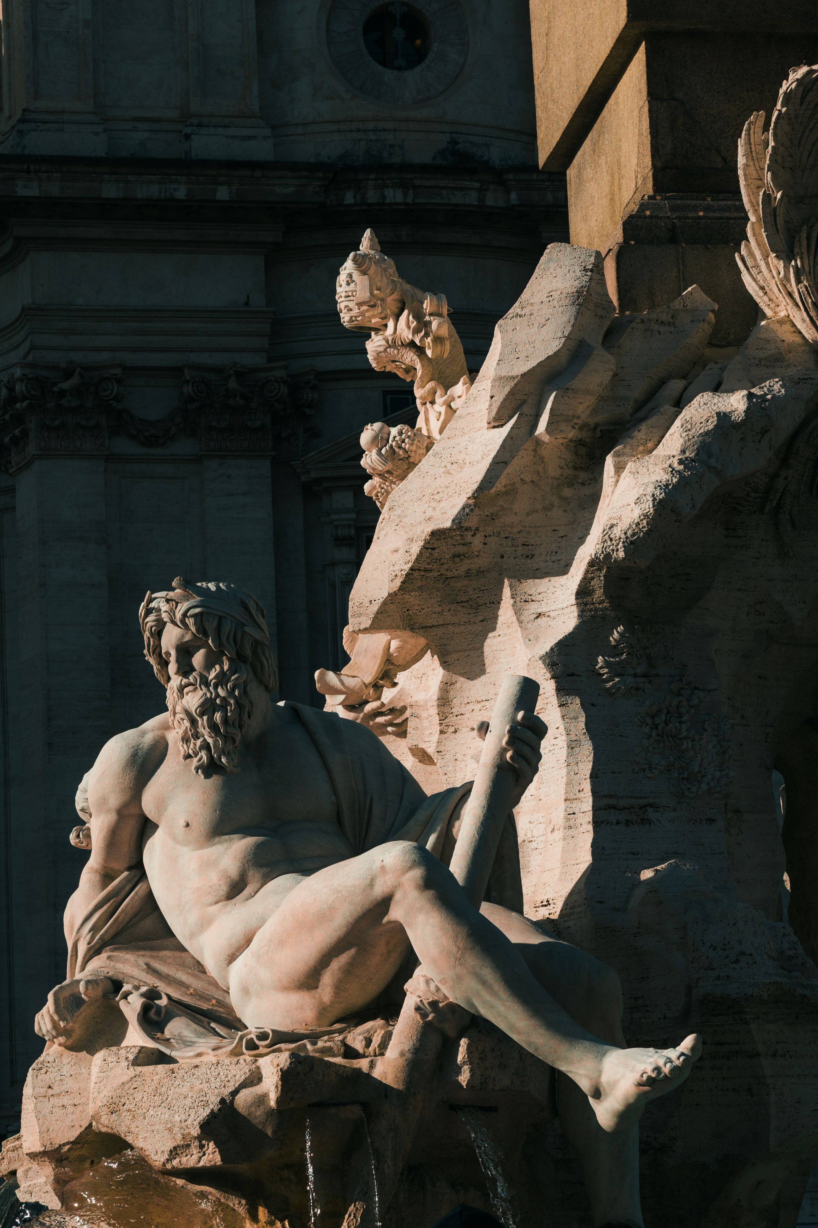 Close-up of a Baroque sculpture at Piazza Navona in Rome, showcasing classical artistry.