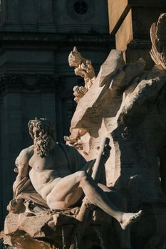 Close-up of a Baroque sculpture at Piazza Navona in Rome, showcasing classical artistry.
