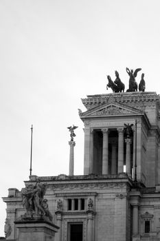 Stunning black and white photo of Altare della Patria in Rome, Italy with dramatic architecture on display.
