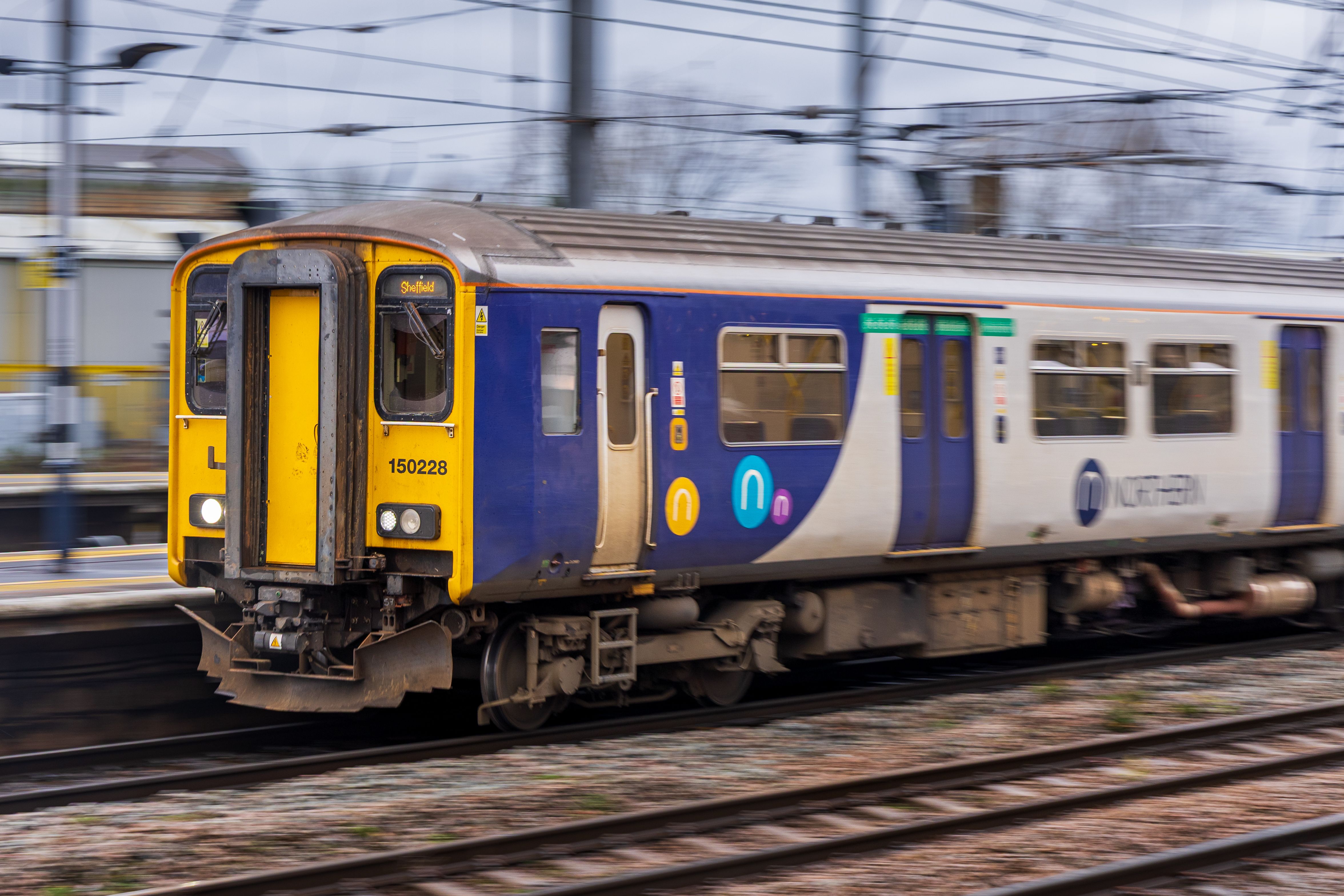 Fast-moving Northern Rail train captured on track in England, showcasing speed and modern transportation.