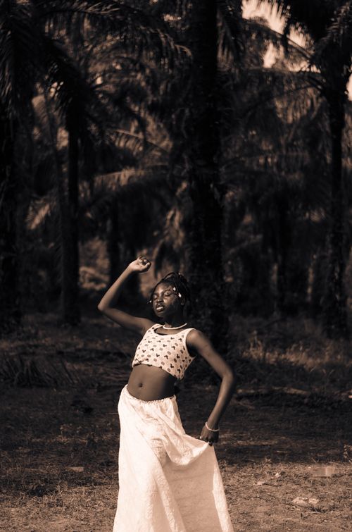 Free A girl poses confidently in a palm tree grove in Gaga, Nigeria. Stock Photo