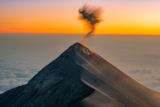 Dramatic sunset over an erupting volcano in Sacatepéquez, Guatemala.
