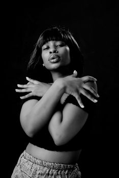 Artistic black and white portrait of a woman in a confident pose.
