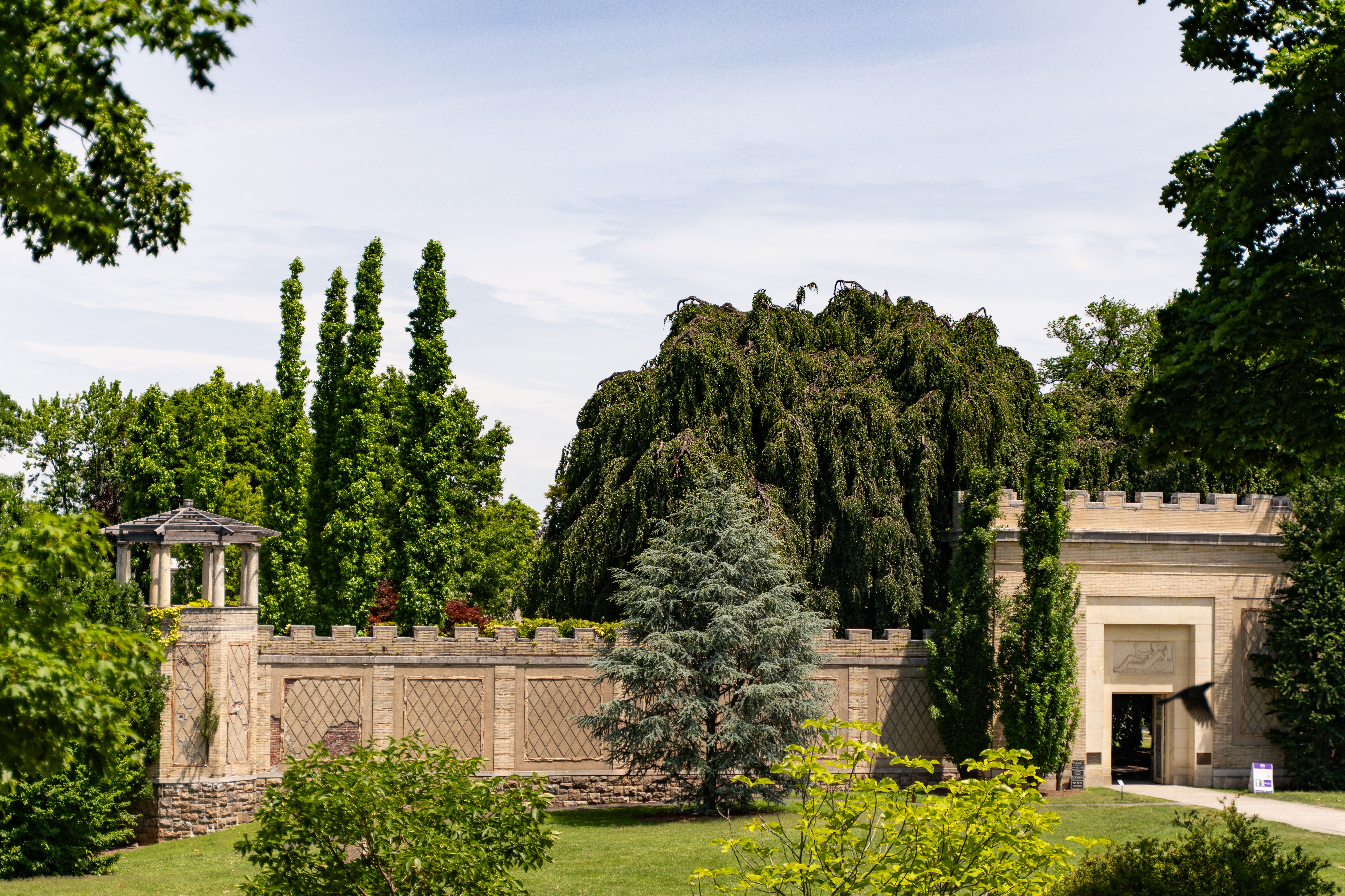 Beautiful historic garden entrance surrounded by lush greenery in Yonkers, New York.