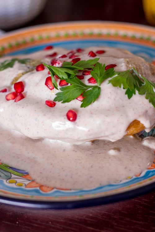 Free Close-up of Chiles en Nogada, a traditional Mexican dish with creamy walnut sauce and pomegranate seeds. Stock Photo
