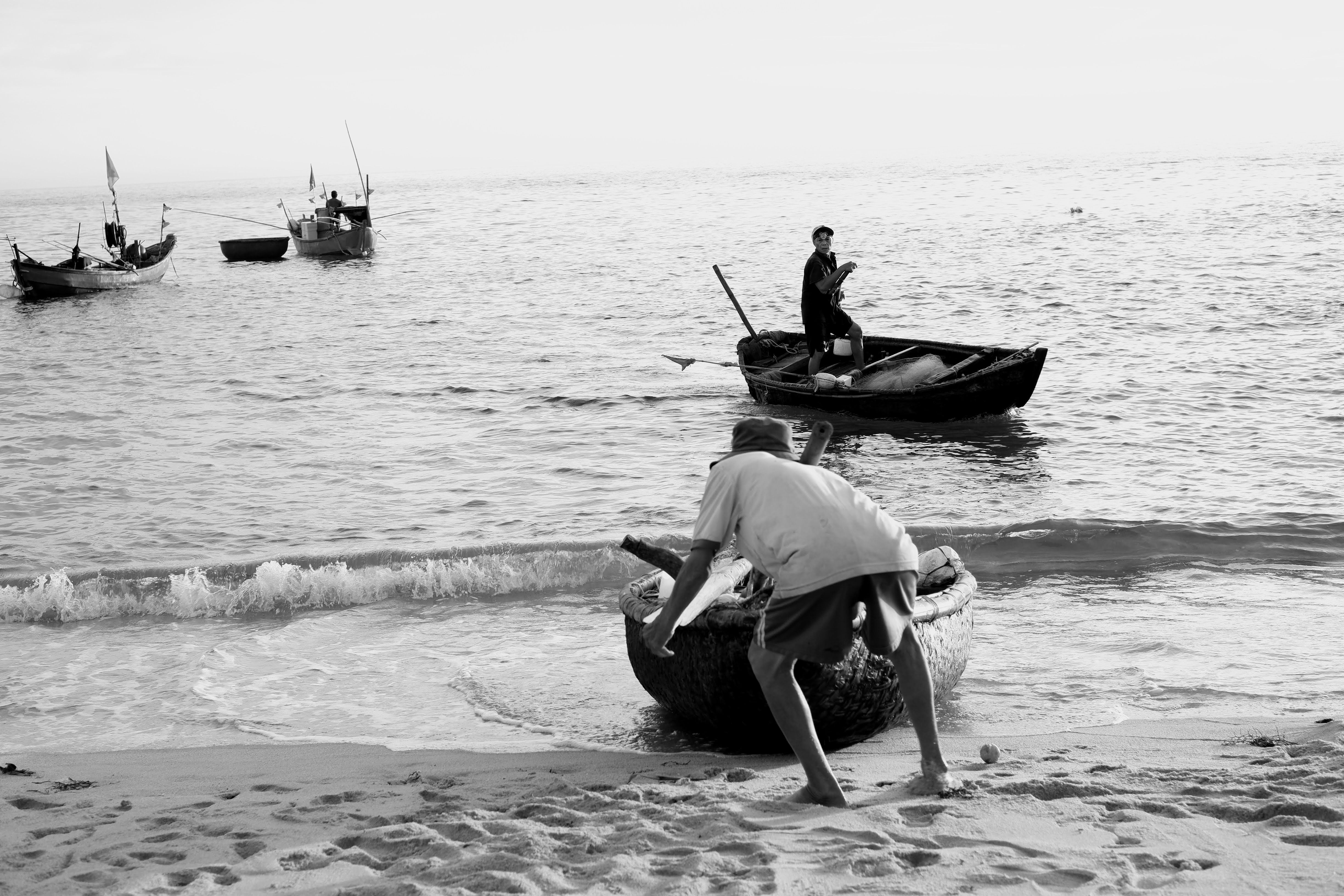 Fishermen in traditional boats engage in daily fishing activities in Sa Huynh, Vietnam.