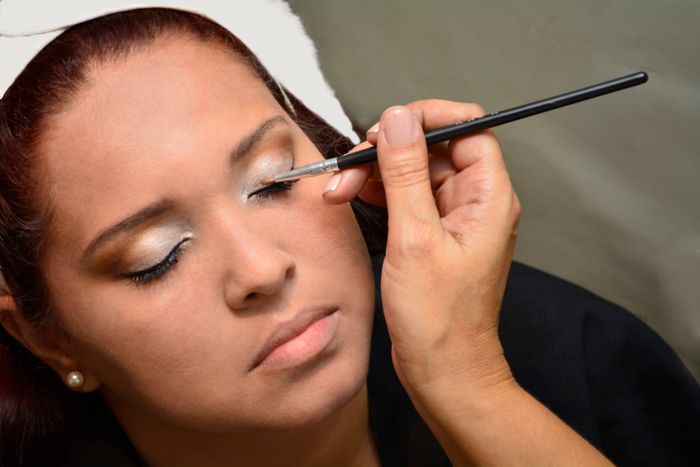 Close-up of precise eye makeup application with a brush