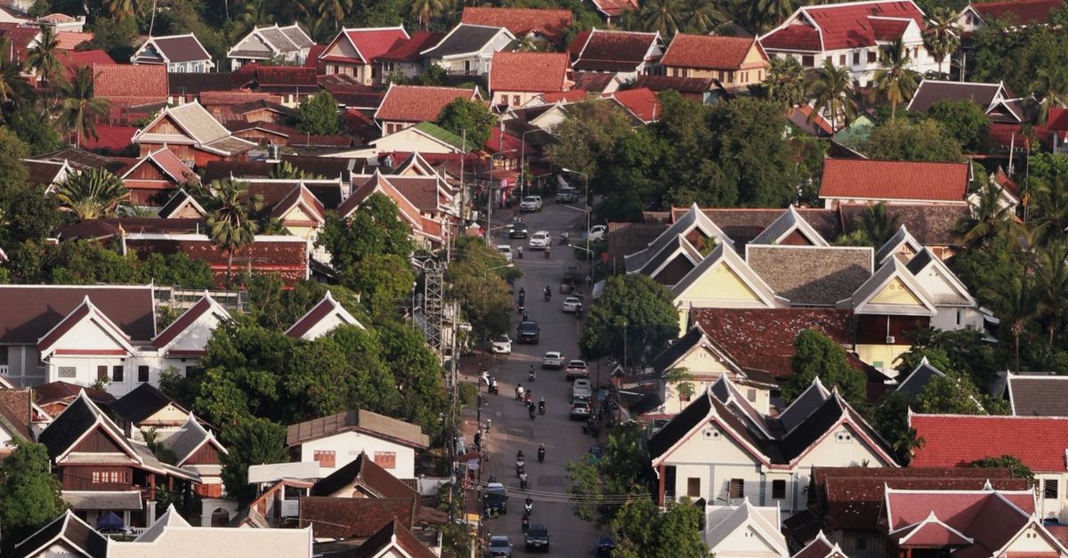 Aerial view of Luang Prabang showcasing traditional Lao architecture and greenery.