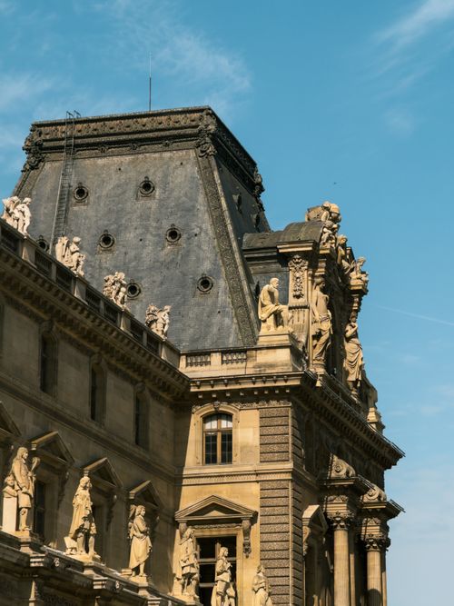 Free Detailed view of the architectural sculptures on the Louvre Museum in Paris. Stock Photo