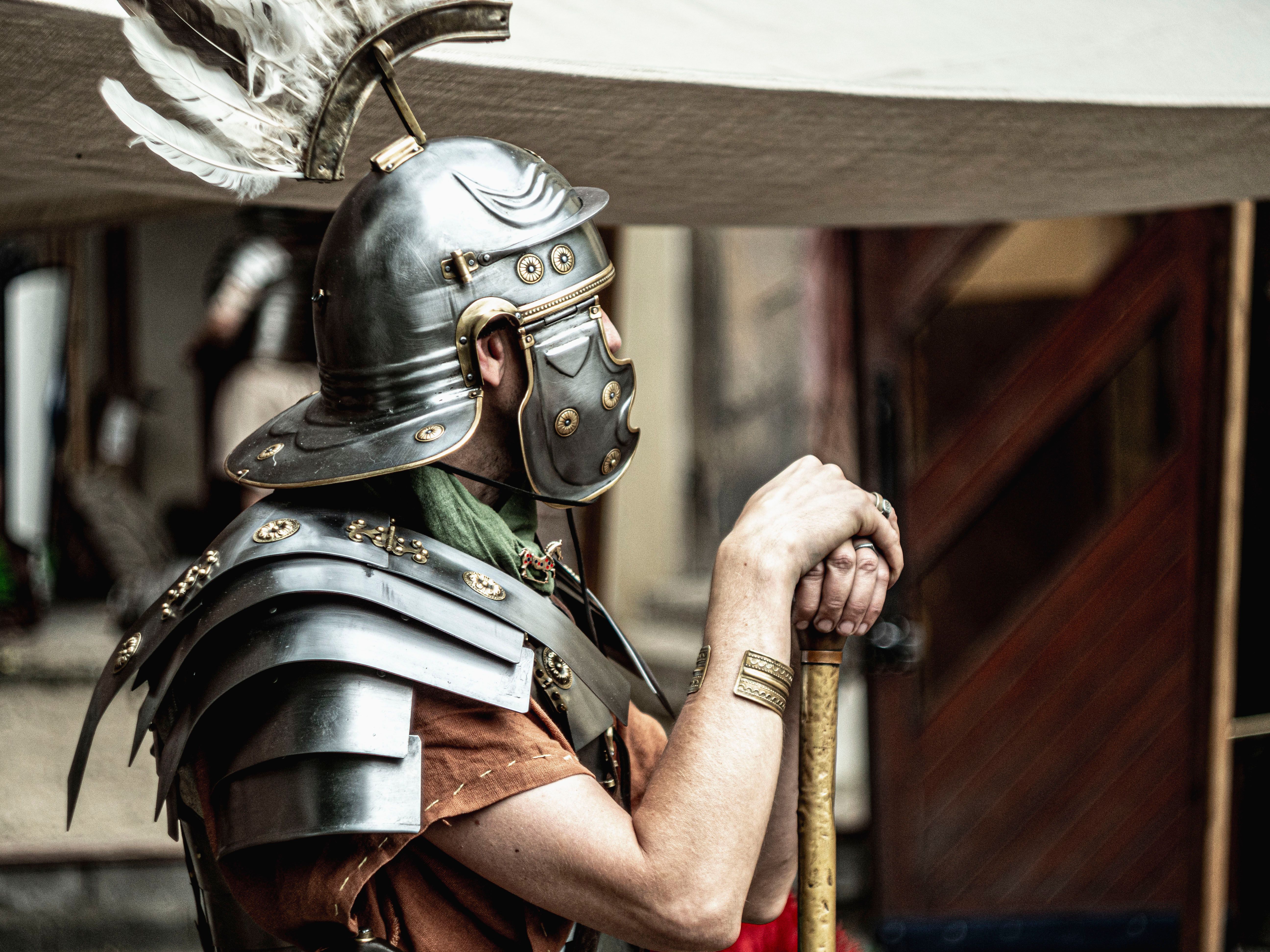 A Roman legionary in full armor, showcasing historical attire with a feathered helmet.