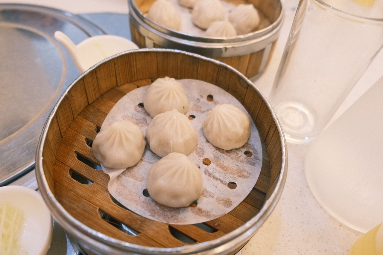 delicious steamed dumplings served in a traditional bamboo basket