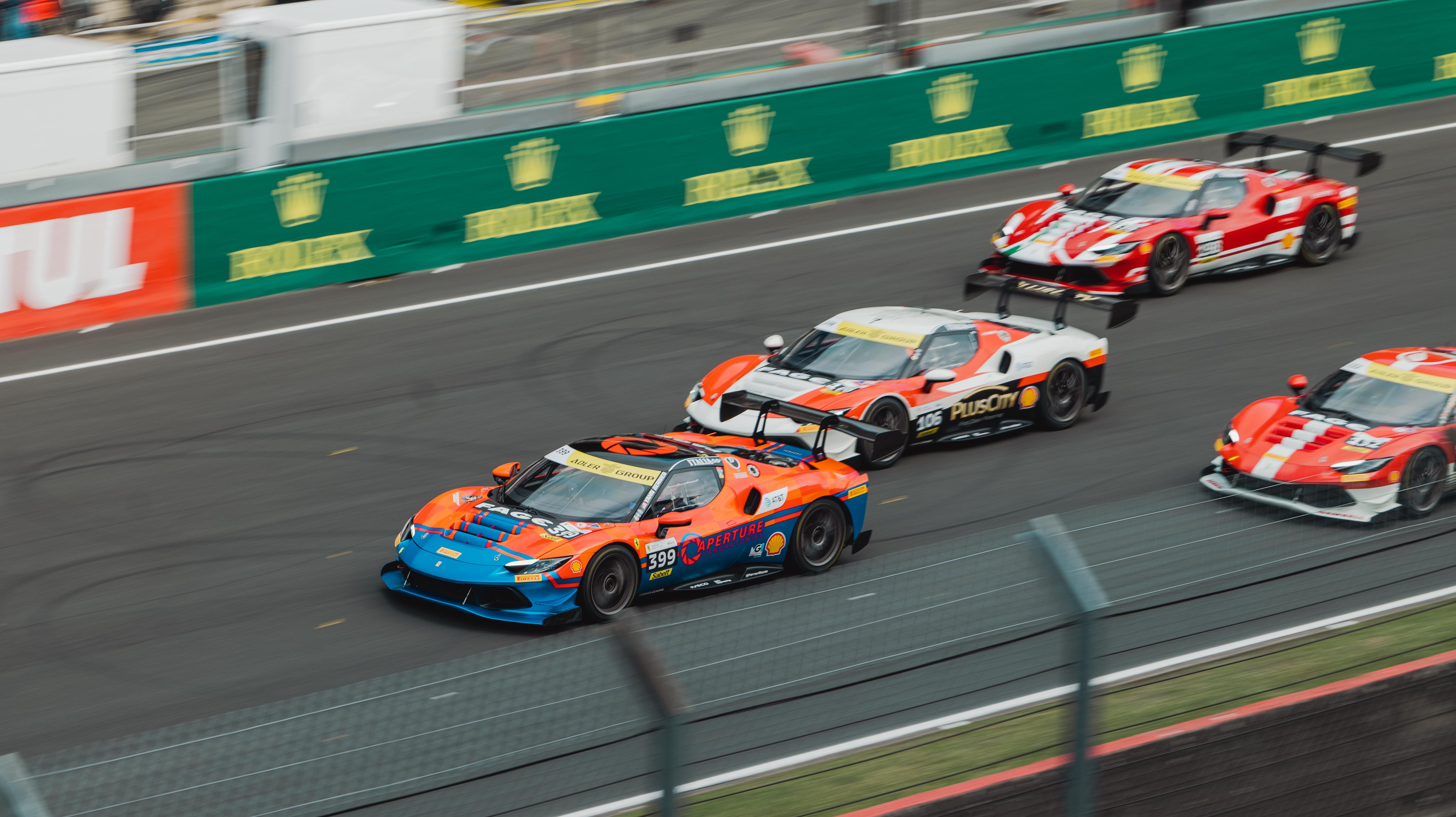 High-speed sports cars racing on the track at Le Mans, France with vibrant colors and energy.