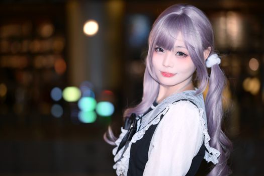 Charming portrait of a cosplayer with lavender hair, dressed in a vintage-inspired outfit.