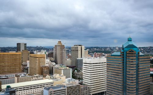 Free A stunning aerial view of Durban's modern skyline with high-rise buildings and an overcast sky. Stock Photo