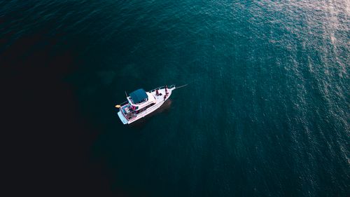 Free Aerial shot of a yacht cruising on calm blue waters. Perfect for travel and maritime themes. Stock Photo