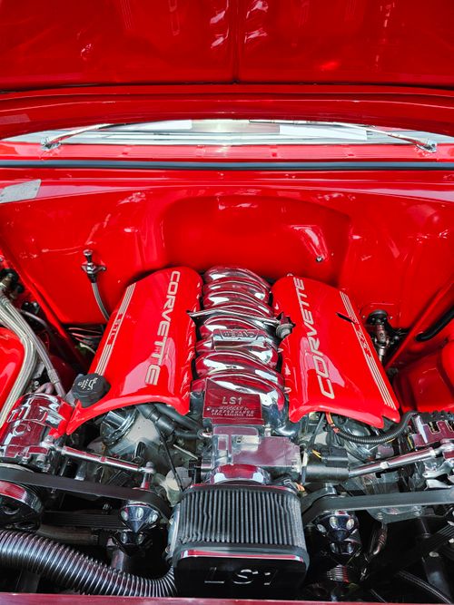 Free Close-up view of a shiny red Corvette engine, showcasing mechanical details and polished chrome. Stock Photo