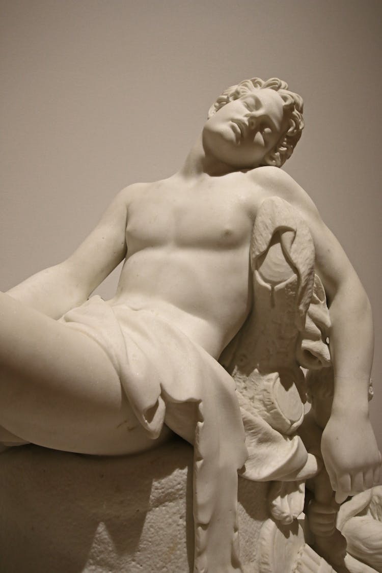 Classic Stone Sculpture Of Resting Male