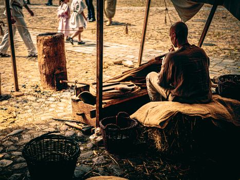 A craftsman at a historical festival in Wrocław, showcasing traditional craftsmanship techniques outdoors.