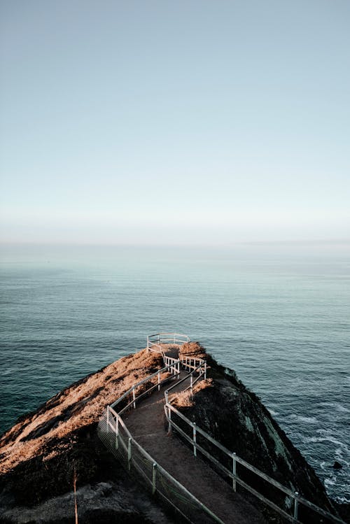 Walkway on cliff above endless ocean