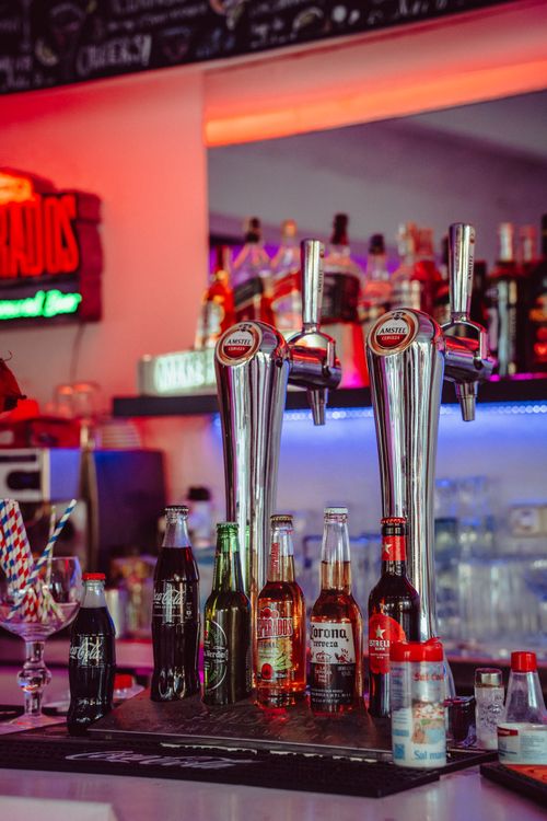 Free Vibrant bar scene with drinks on counter in Lloret de Mar, Spain. Stock Photo