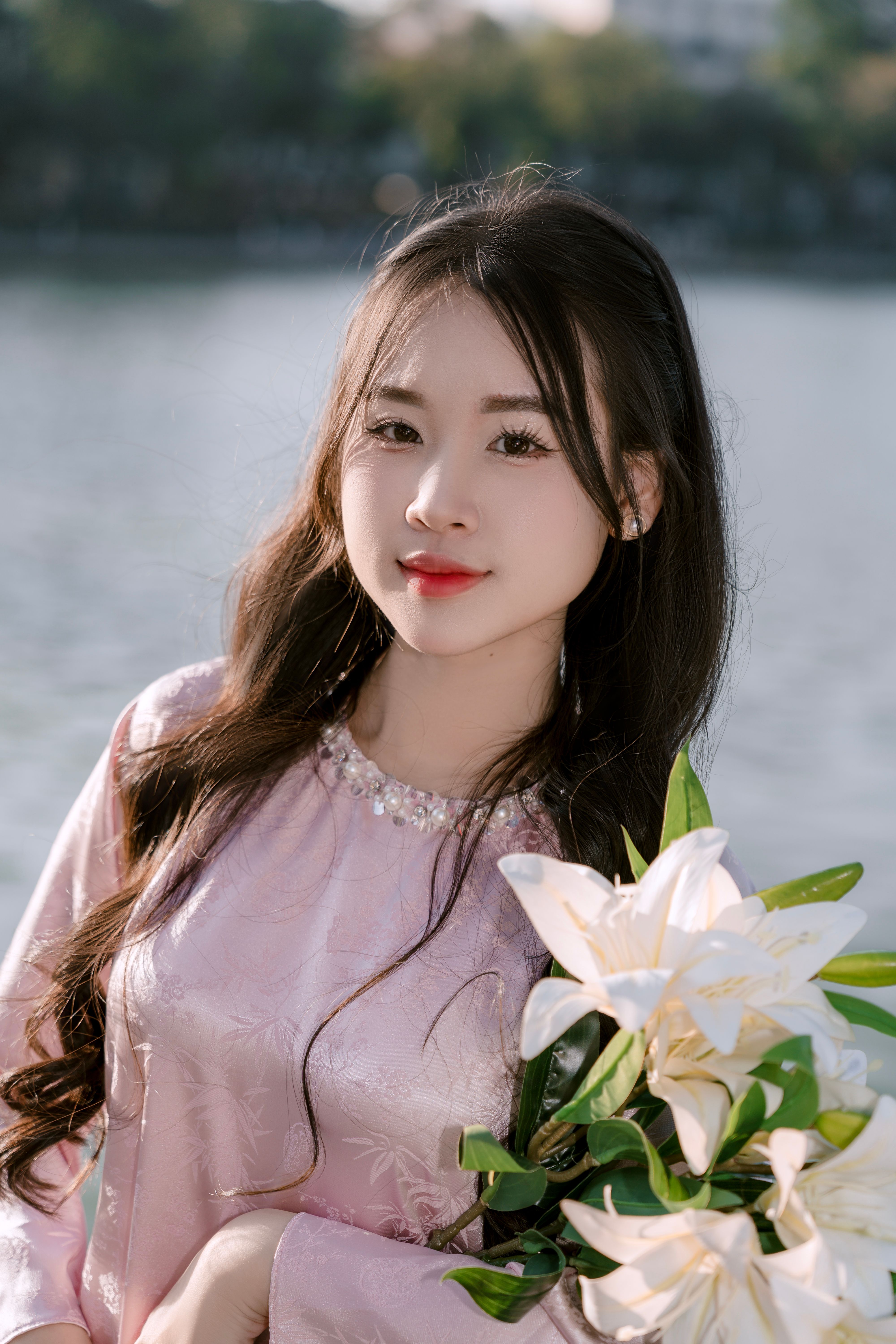 Portrait of Young Woman with Lily Bouquet by River
