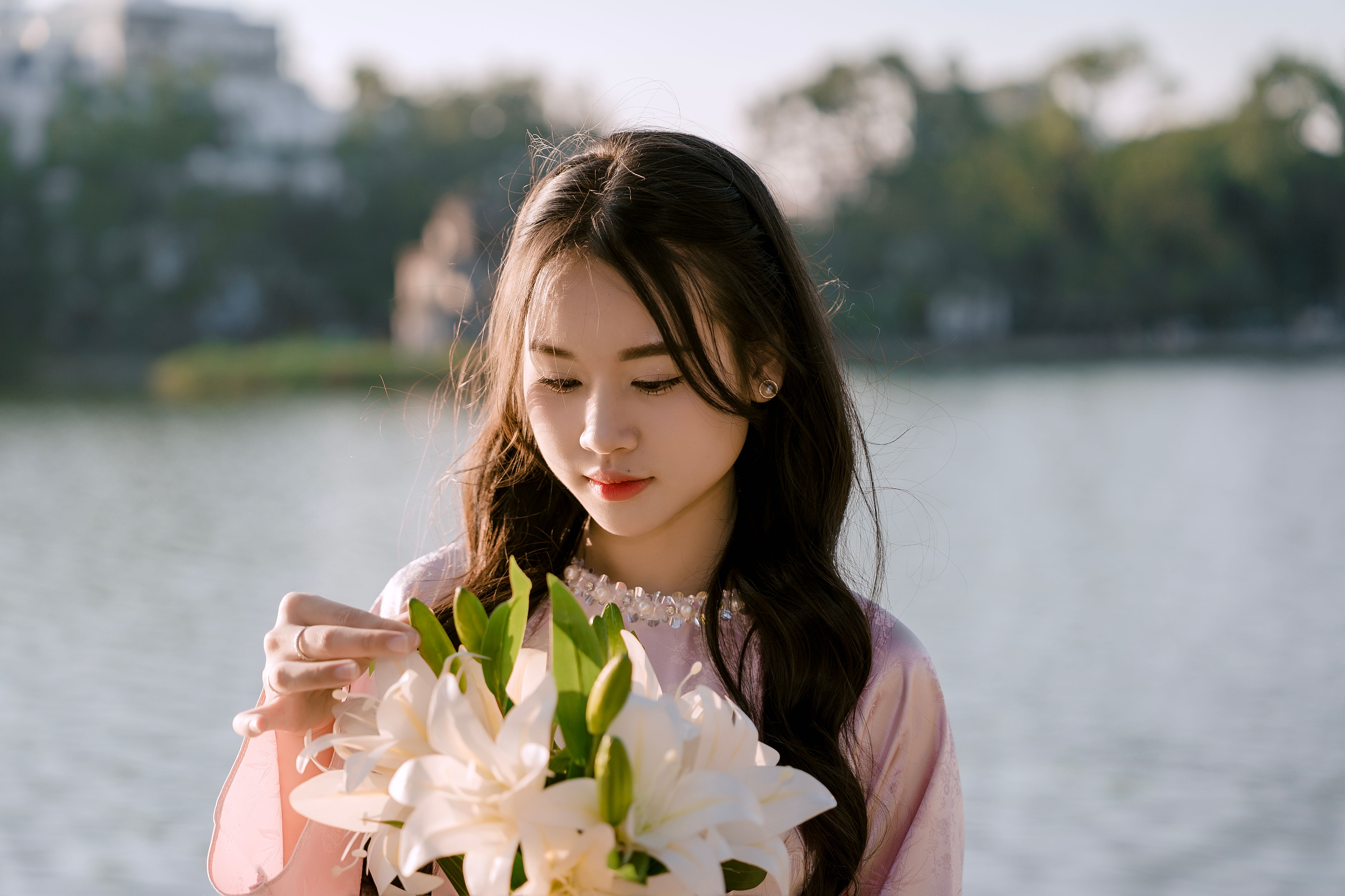 Young Woman with Flowers by the Lake
