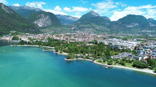 Free A vibrant aerial view of Lake Idro surrounded by lush greenery and Alpine mountains. Stock Photo