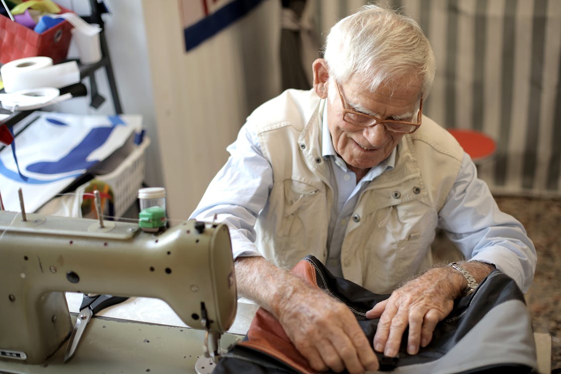 Free Photo of Man Sewing Stock Photo