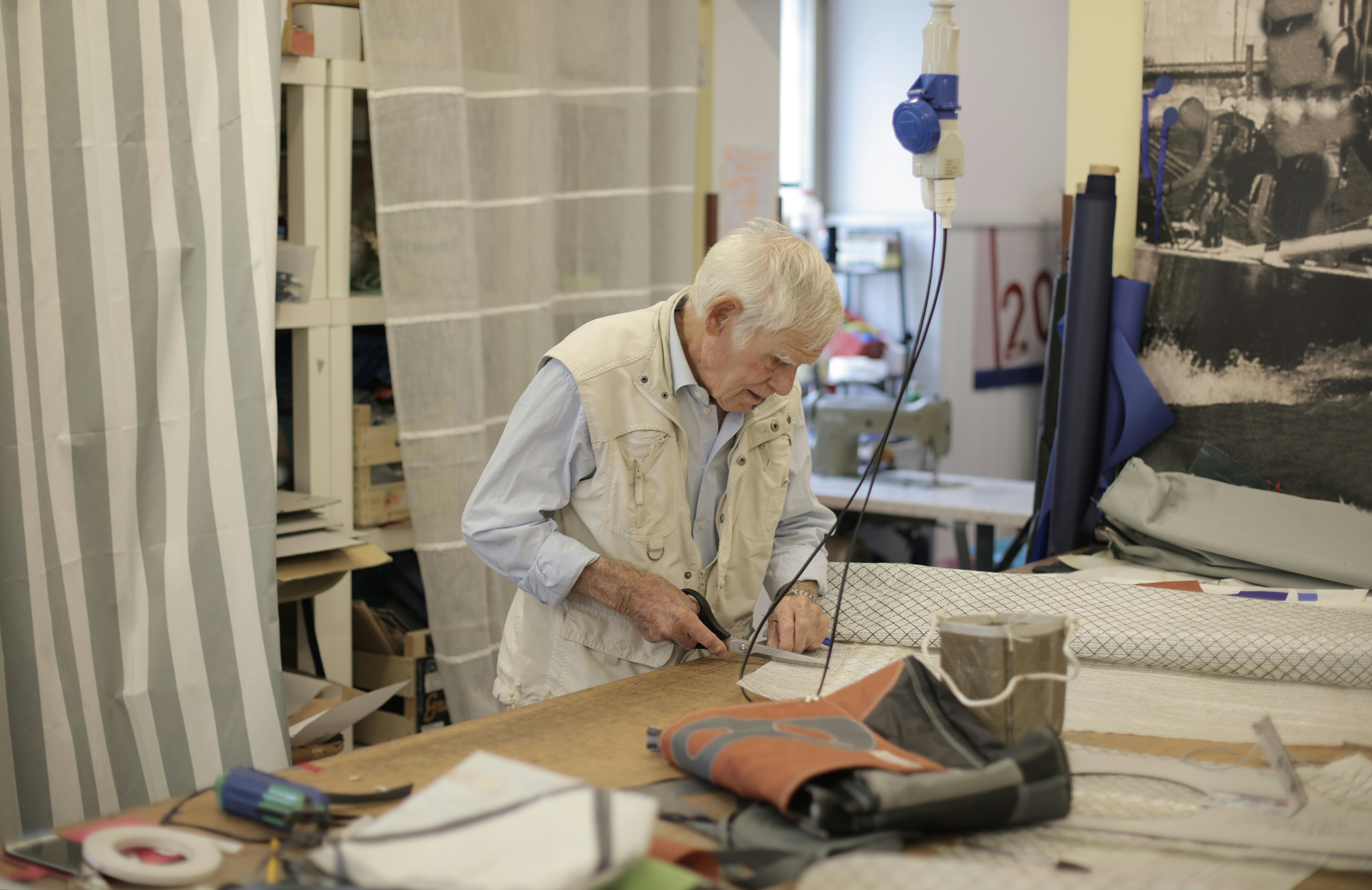 photo of man cutting using scissors